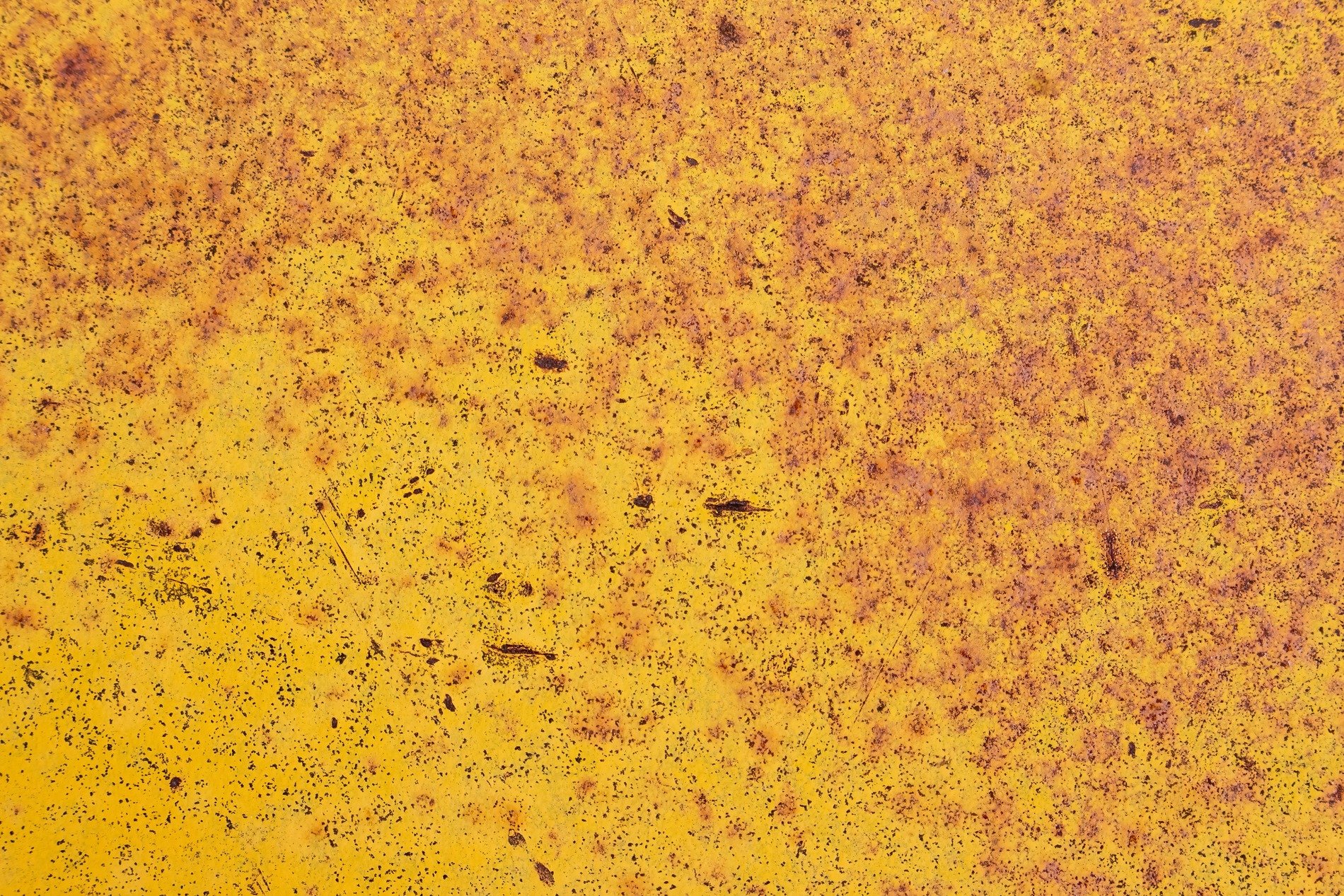 Yellow paint decays, iron oxide blooms on steel, time eats through the coat