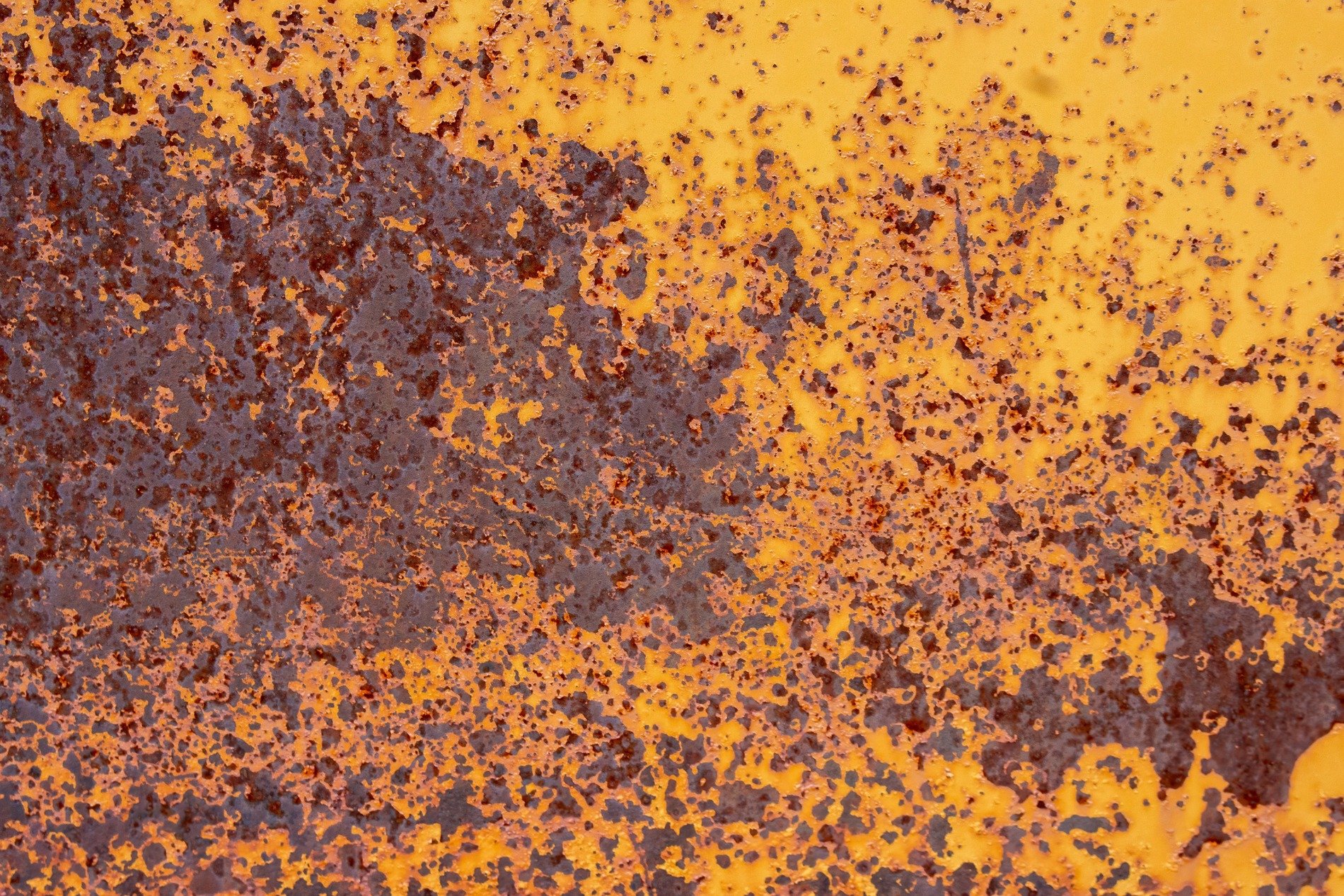 Yellow paint yields ground, brown oxidation spreads out, rust claims every inch