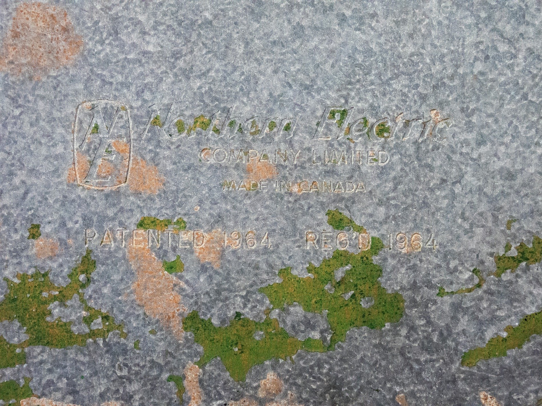 Cold galvanized steel, moss and rust creep o'er the words, sixty four remains