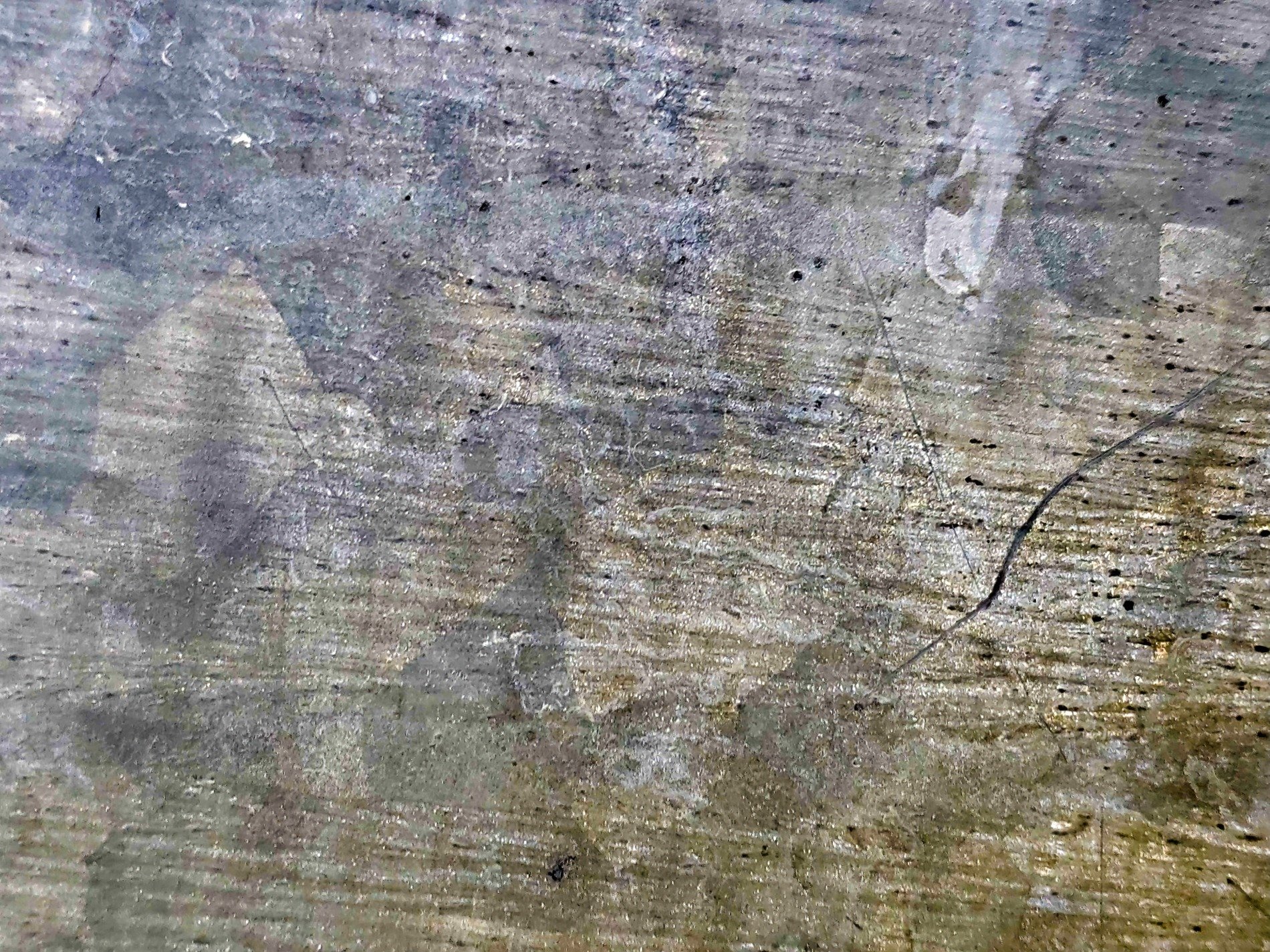 Zinc patterns emerge, scratches mark the cold surface, silver turns to dust