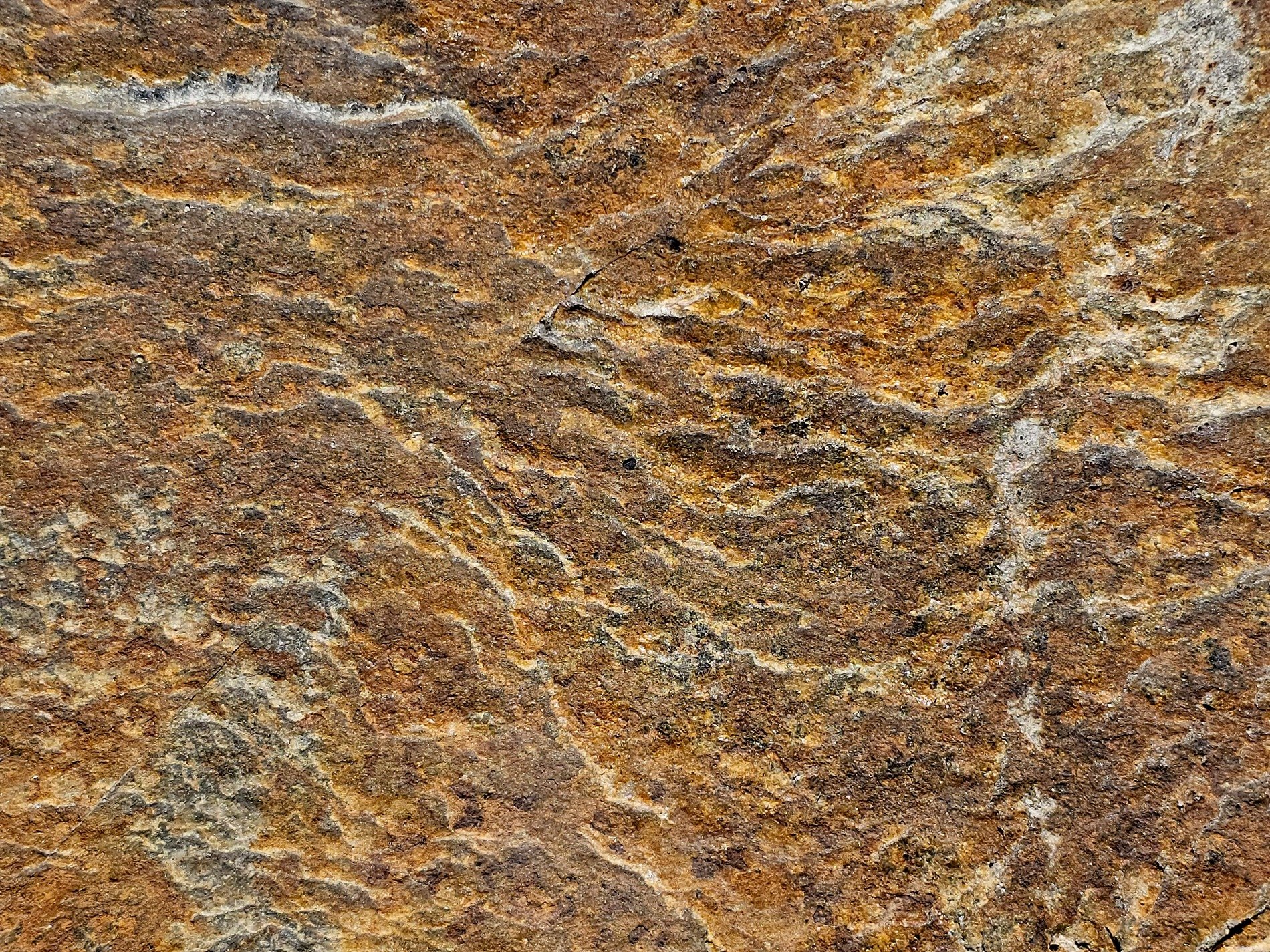 Ancient layers rest, iron rust bleeds through the cracks, stone holds onto time