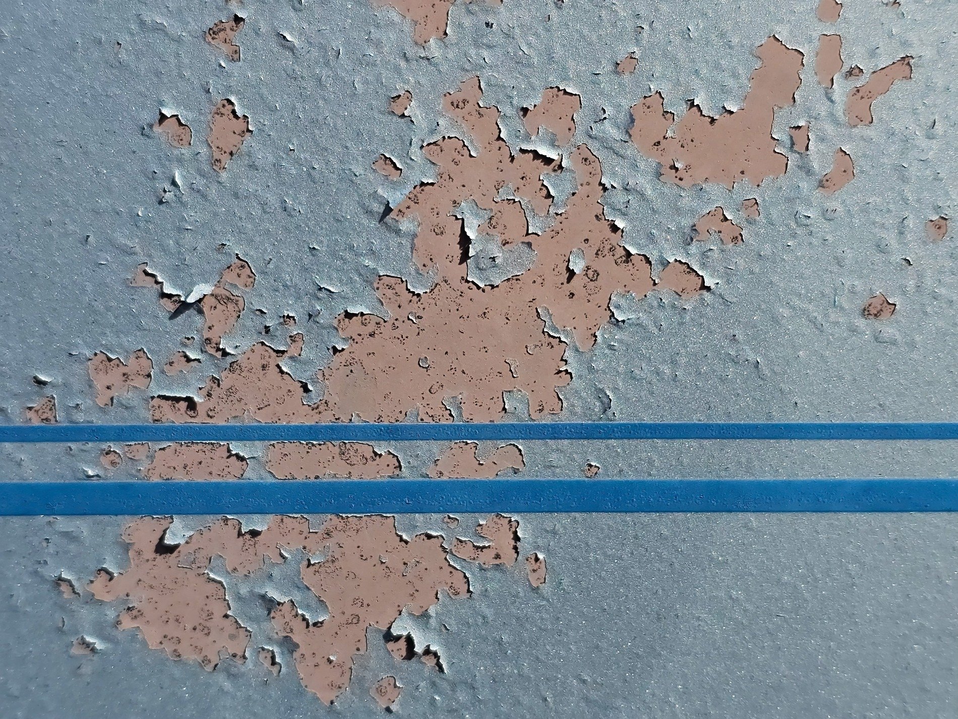 Blue paint starts to curl, stripes of azure cut the plane, dusty rose beneath