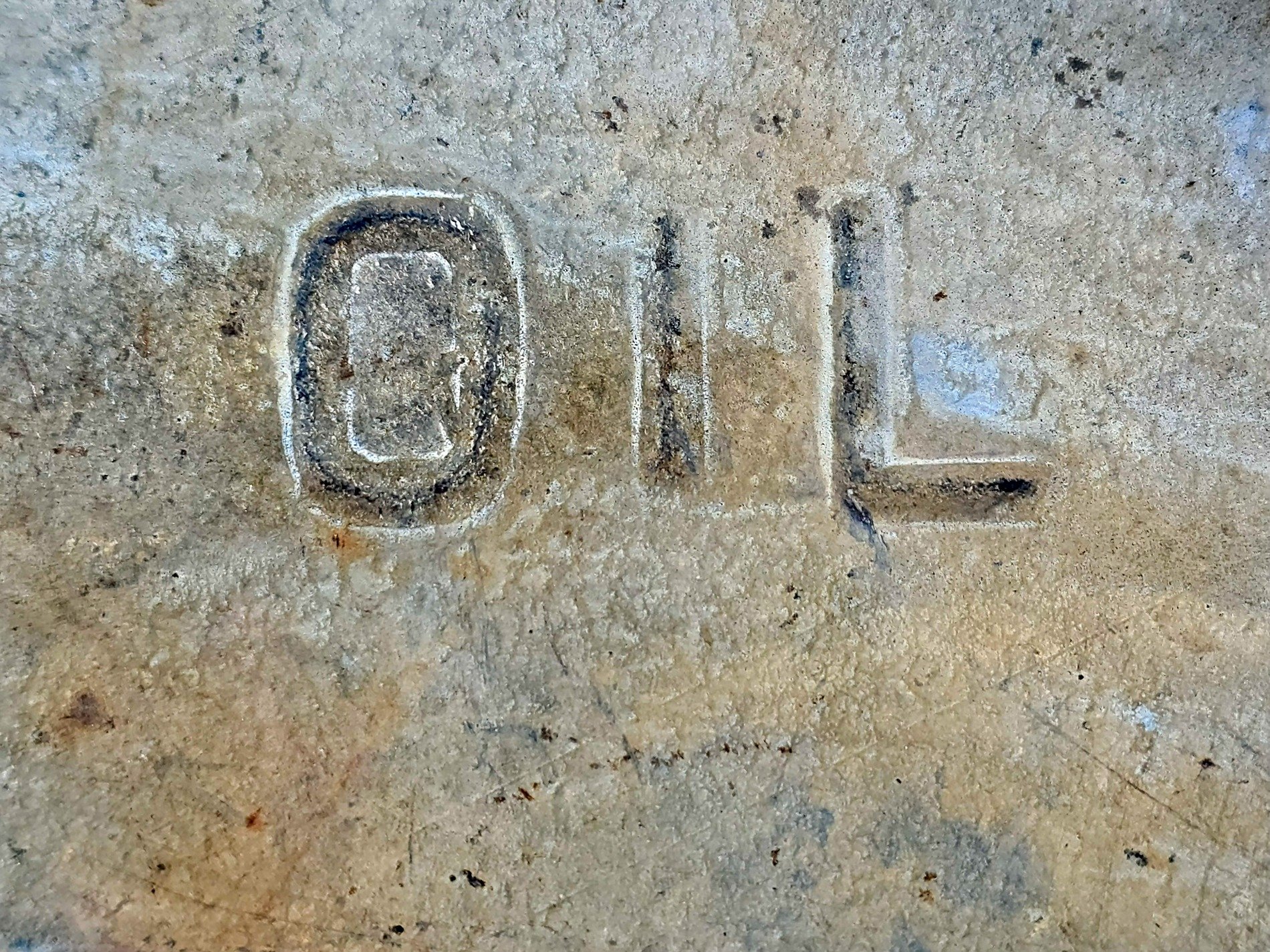 Cold metal bears mark, oil etched in the pitted skin, industrial ghost
