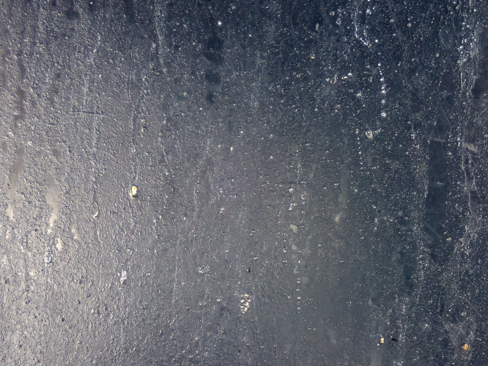Dark pane holds the mist, silver droplets cling to cold, shadows hide within