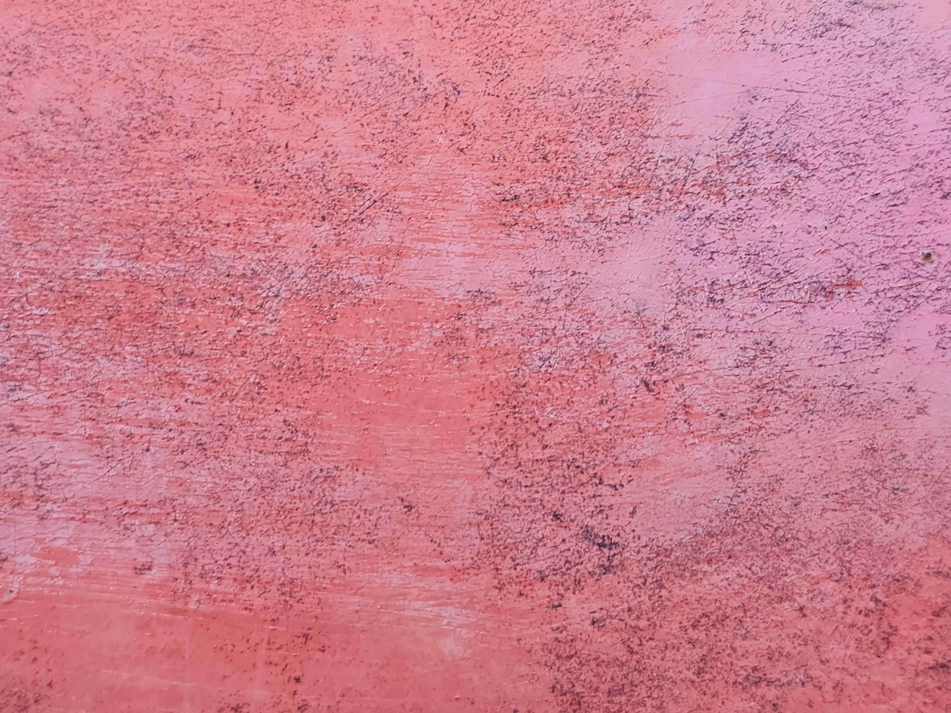 Pink paint starts to fade, scratched by time's relentless hand, rough texture remains