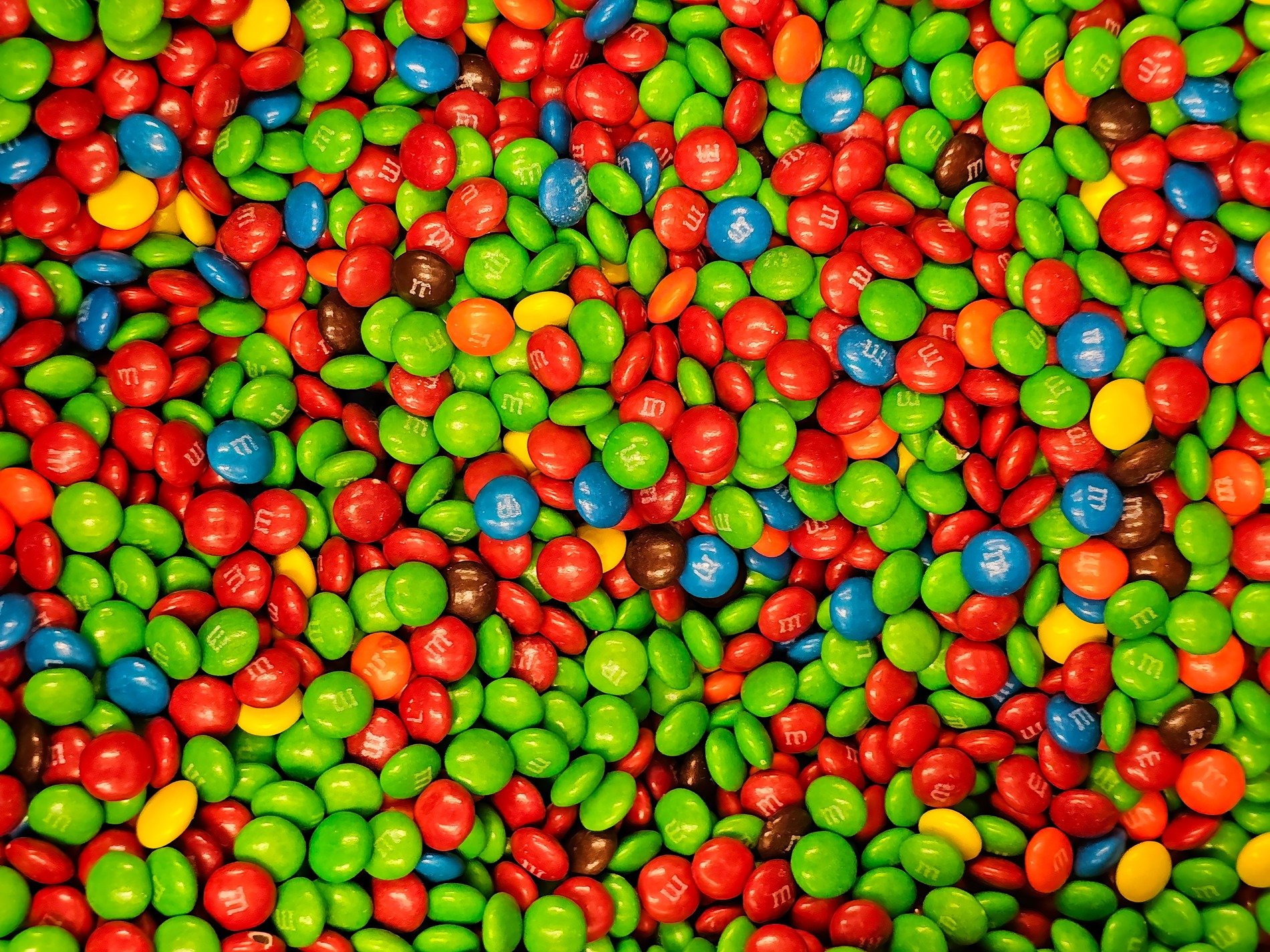 Rainbow gems collide, hard shells hide a sweet surprise, circles fill the frame