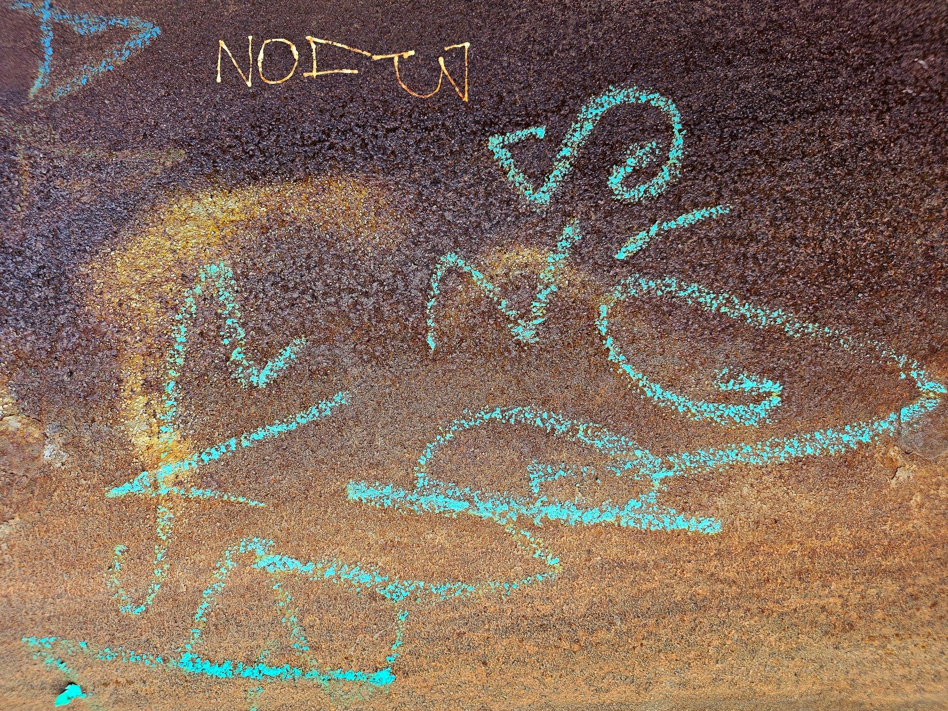 Rust claims the iron, teal chalk marks the weathered wall, decay finds a home