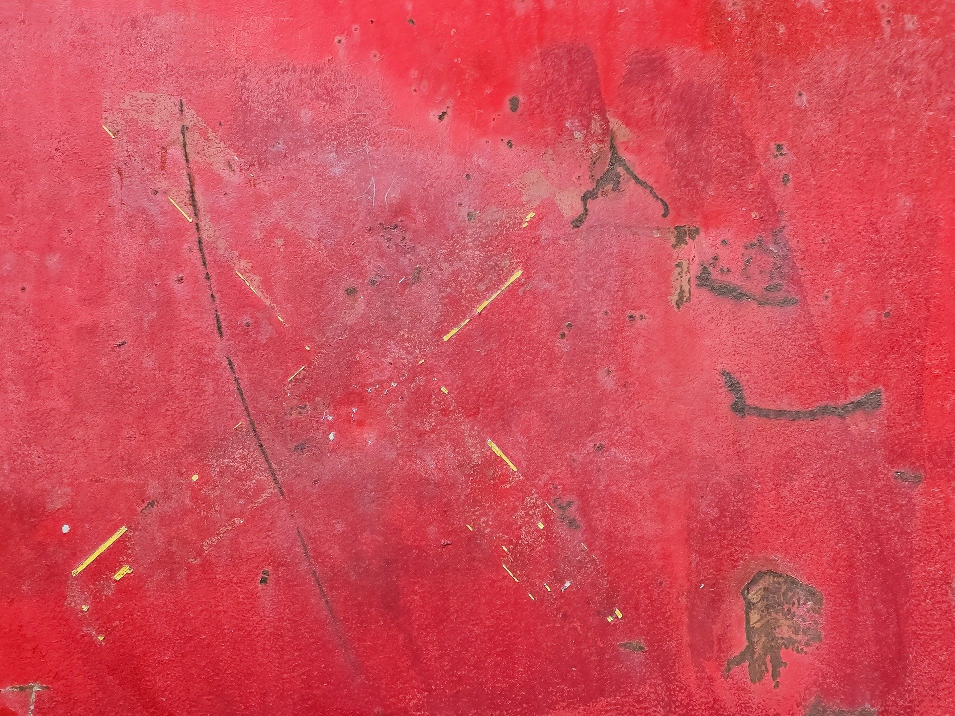 Scratched red surface, time scars the aging metal, rust blooms in the dark