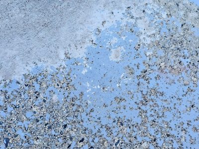 Blue paint flakes away, hard stone grit reveals itself, time wears down the floor