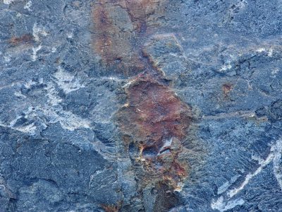 Blue rock meets the rust, frozen rivers of white line, time stains every grain