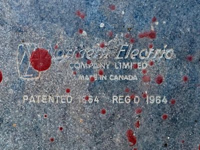 Blue steel holds the name, crimson splatters stain the text, legacy in metal