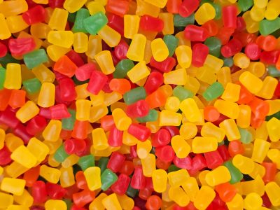 Bright gems of sugar, red and yellow tumble down, sweet chewy delight