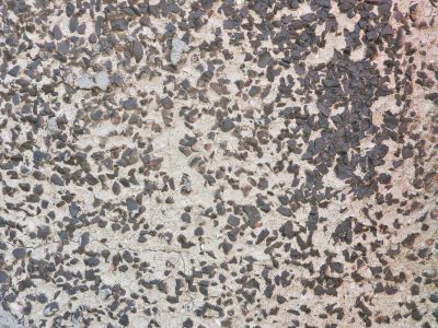 Dark chips biting deep, held within a pale embrace, texture speaks of grit