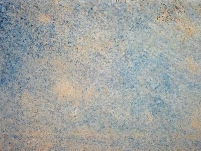 Pale blue mist fades, tan earth stains the ancient stone, textures wear with time